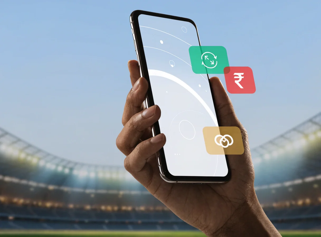 Android phone held in a cricket stadium with payment-style app icons